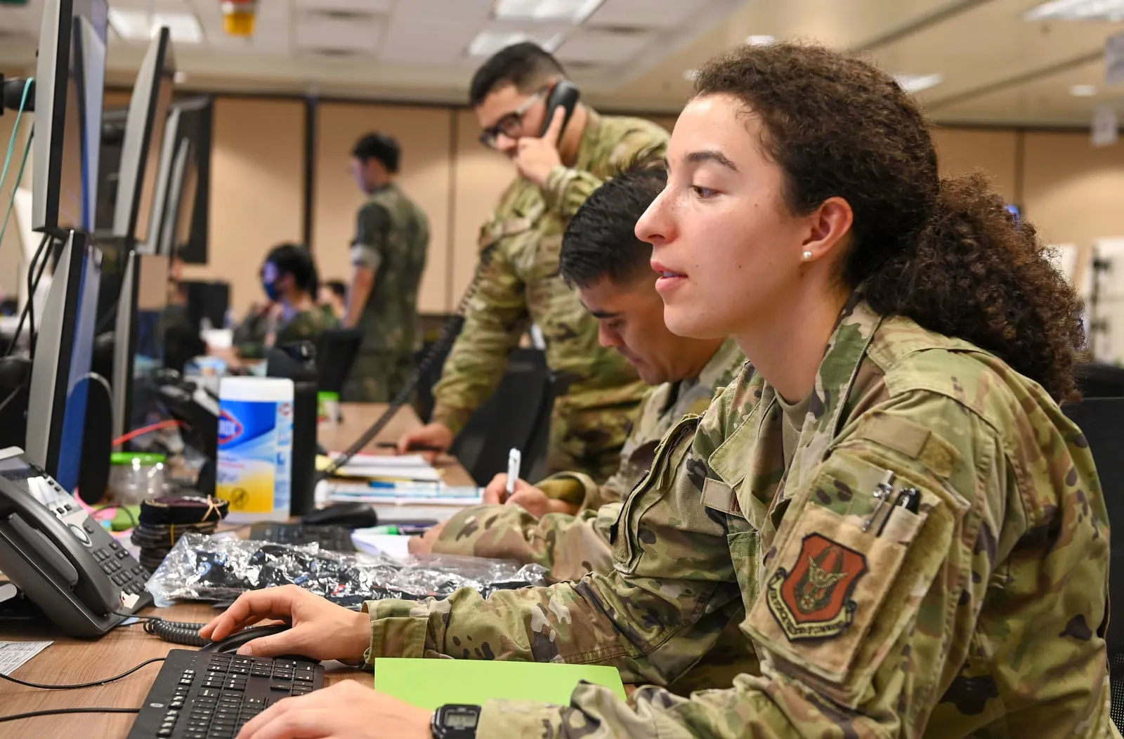 Analysts and operators working side by side at mission workstations